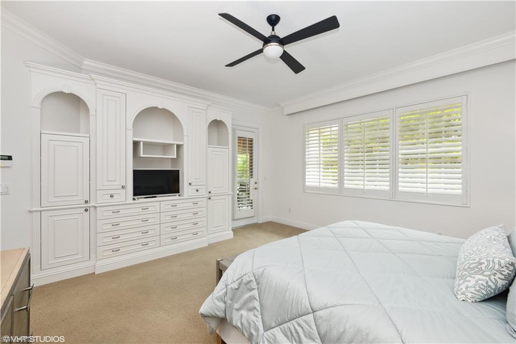 6501 Crown Colony Place, Unit 4201 Naples, FL 34108 - Photo 22 of 35 a bedroom with a bed and a flat screen tv