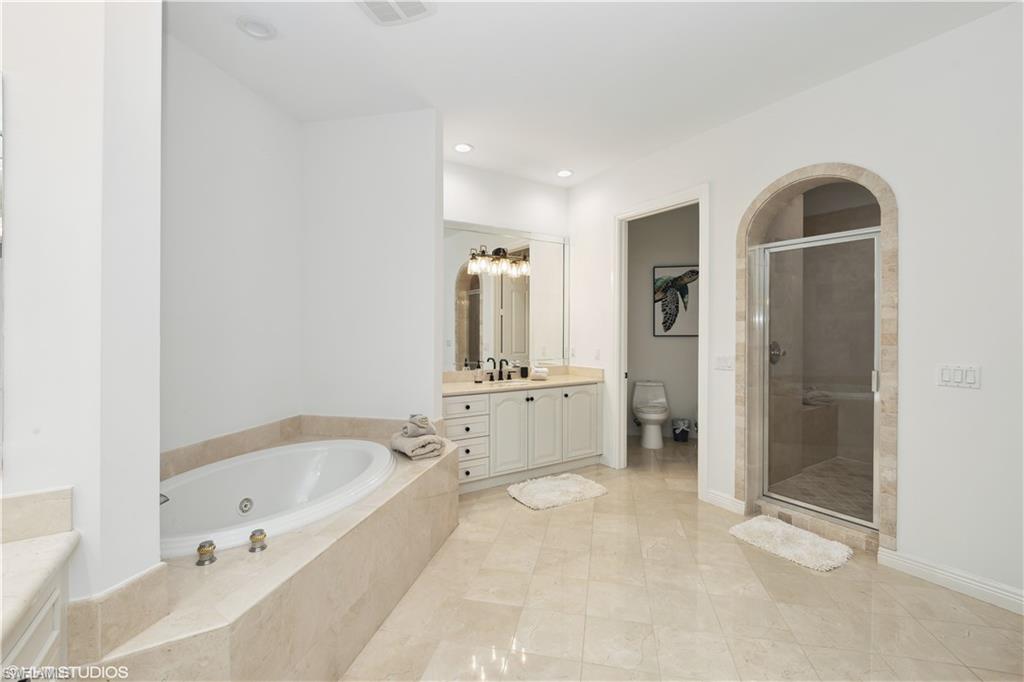 6501 Crown Colony Place, Unit 4201 Naples, FL 34108 - Photo 24 of 35 a bathroom with a bathtub and a shower