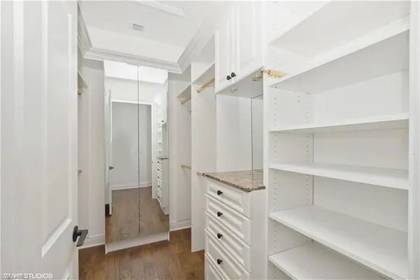 a view of walk in closet with empty racks