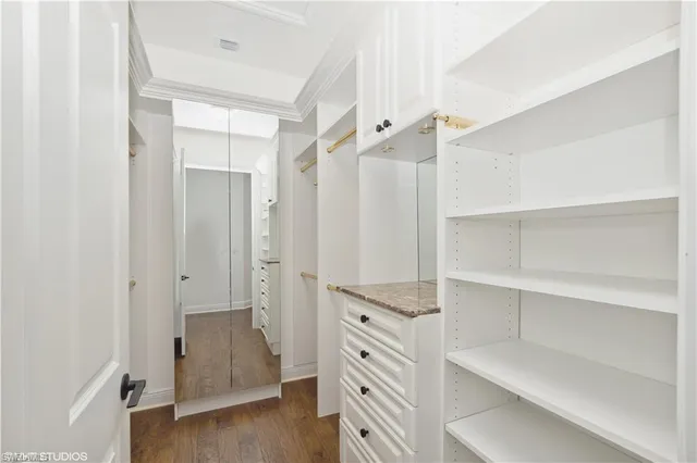 a view of walk in closet with empty racks