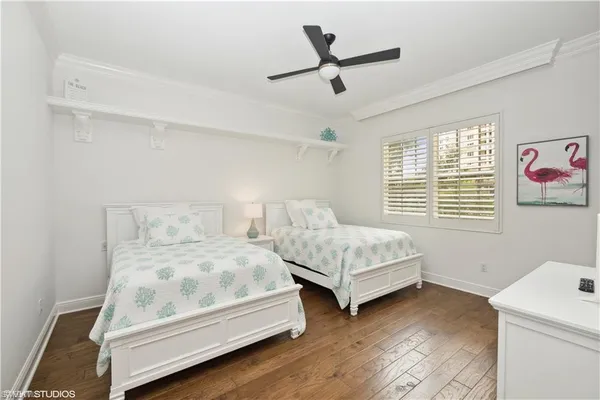 a bedroom with two beds and a window