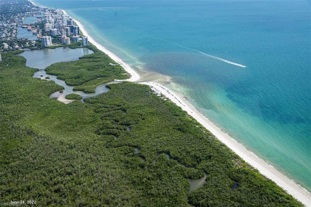 6501 Crown Colony Place, Unit 4201 Naples, FL 34108 - Photo 31 of 35 a view of a lake with a building in the background