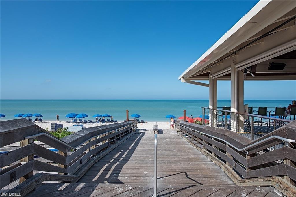 6501 Crown Colony Place, Unit 4201 Naples, FL 34108 - Photo 34 of 35 a roof deck with a table and chairs