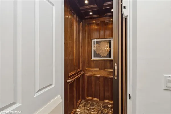 a bathroom with a glass door shower and a sink