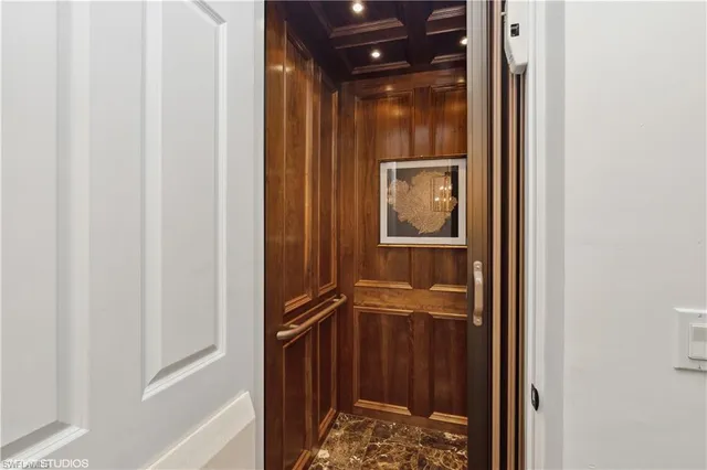 a bathroom with a glass door shower and a sink