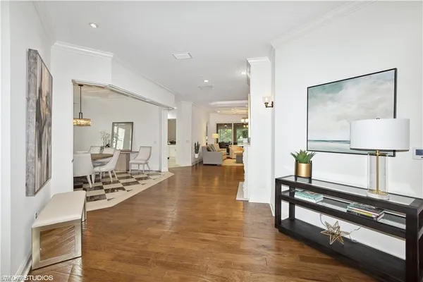a lobby with furniture and a wooden floor