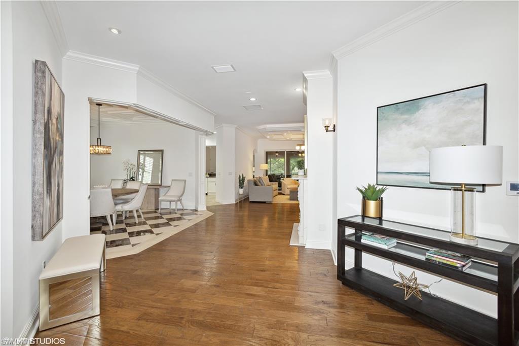 6501 Crown Colony Place, Unit 4201 Naples, FL 34108 - Photo 7 of 35 a lobby with furniture and a wooden floor