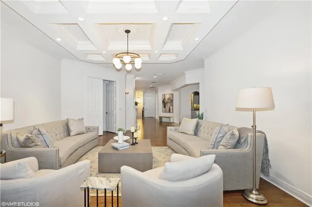 a living room with furniture a lamp and a chandelier