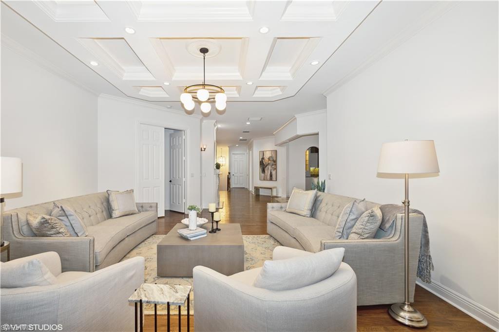 6501 Crown Colony Place, Unit 4201 Naples, FL 34108 - Photo 8 of 35 a living room with furniture a lamp and a chandelier