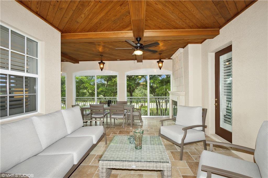 6501 Crown Colony Place, Unit 4201 Naples, FL 34108 - Photo 10 of 35 a living room with furniture and a large window