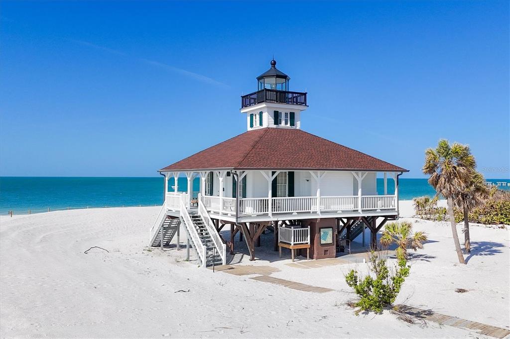 862 Grande Pass Way Boca Grande, FL 33921 - Photo 20 of 22 a roof deck with table and chairs under an umbrella
