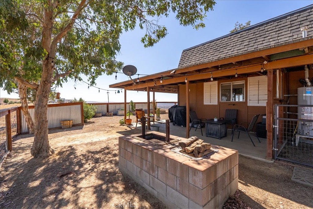 3815 Highway 41 Paso Robles, CA 93446 - Photo 36 of 40 a view of a patio with table and chairs potted plants and floor to ceiling window