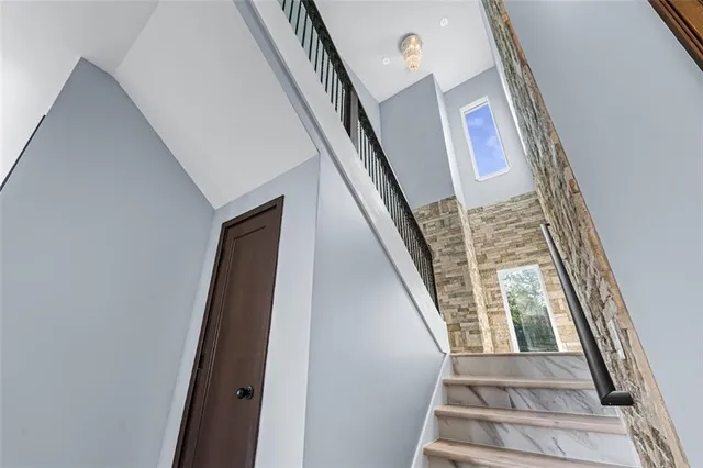 a view of staircase with white walls and a window