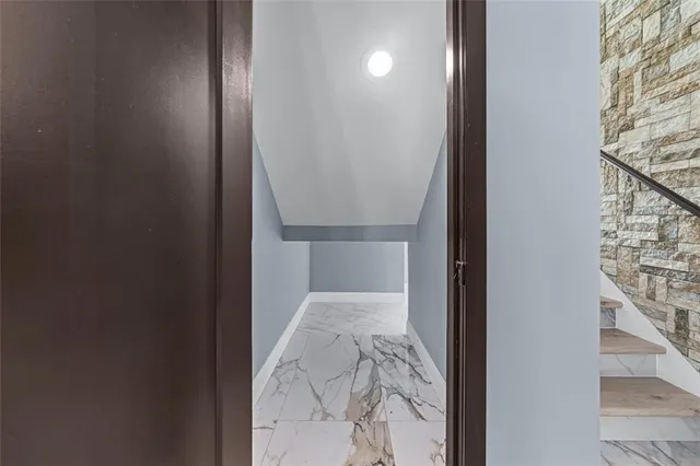 a view of hallway with wooden floor