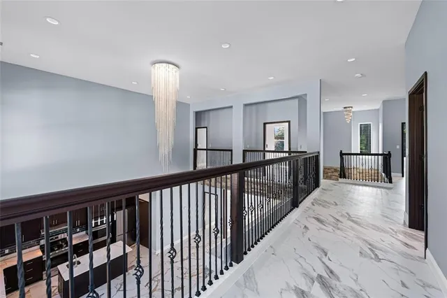a view of a hallway with wooden floor and windows