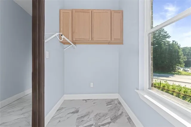 a view of a small space with wooden floor and a window