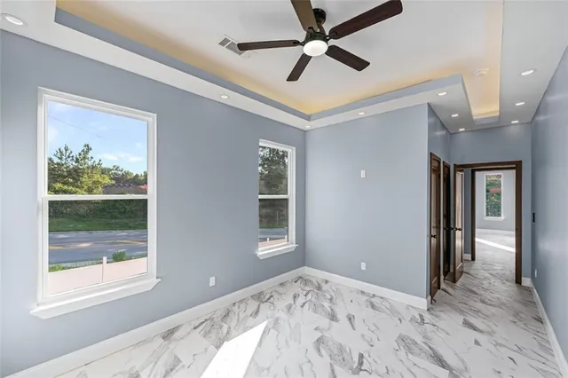 a view of a big house with a big yard and large trees