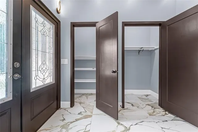 a bathroom with a glass door shower and a sink