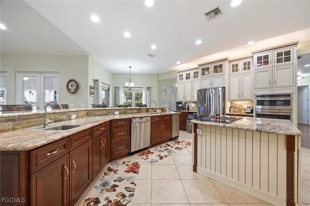 a kitchen with stainless steel appliances granite countertop a sink and cabinets