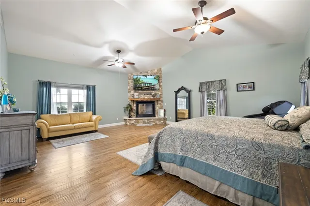 a bedroom with a bed chandelier and a window