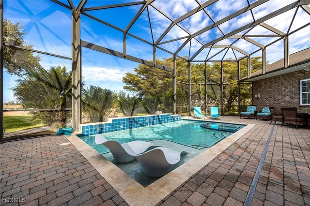 a view of a house with a swimming pool and sitting area