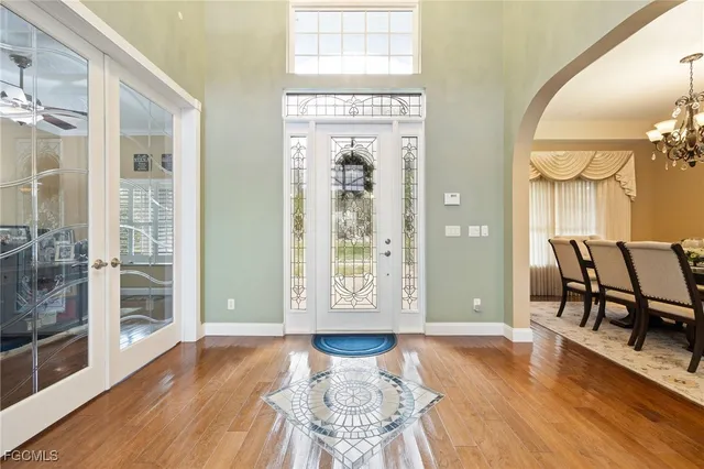 a view of a livingroom with furniture next to a chandelier