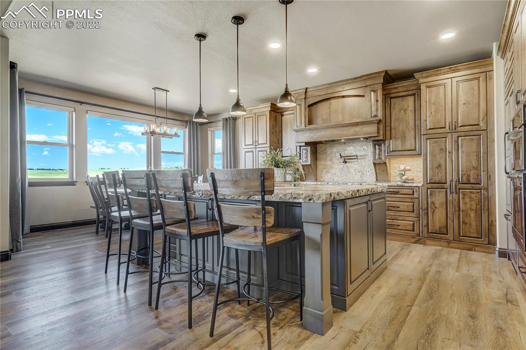 14325 Evans Road Elbert, CO 80106 - Photo 14 of 49 a kitchen with lots of counter space dining table and stainless steel appliances