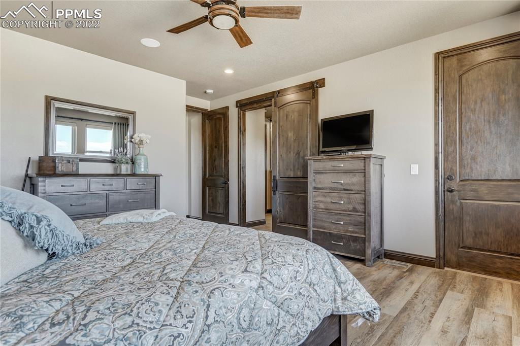 14325 Evans Road Elbert, CO 80106 - Photo 22 of 49 a bedroom with a bed and a flat screen tv