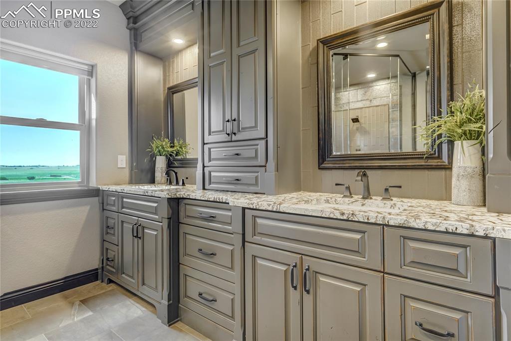 14325 Evans Road Elbert, CO 80106 - Photo 24 of 49 a bathroom with a granite countertop sink and a mirror