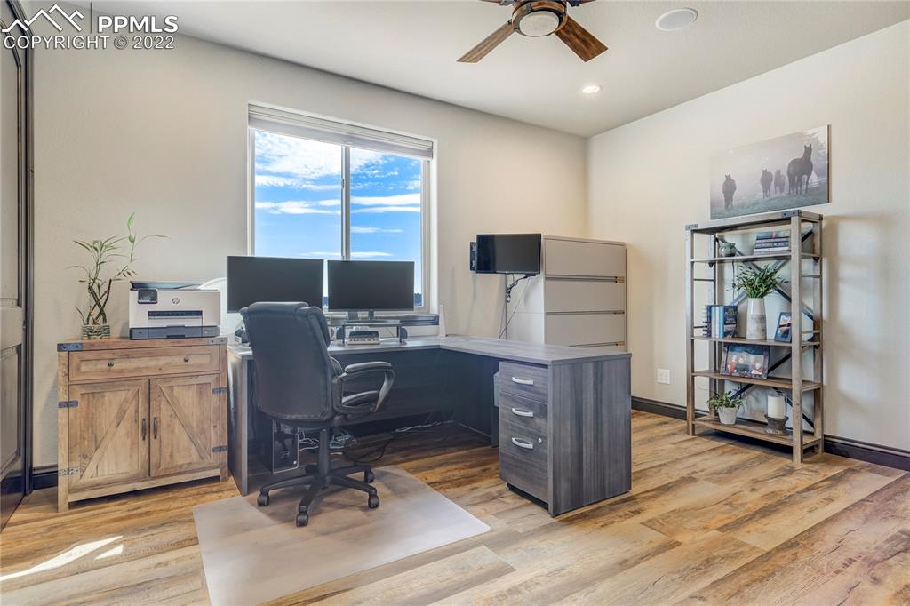 14325 Evans Road Elbert, CO 80106 - Photo 27 of 49 a view of workspace with wooden floor windows