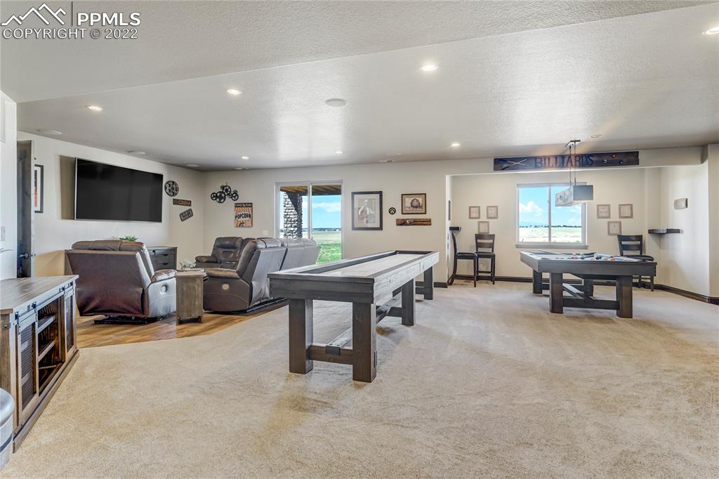 14325 Evans Road Elbert, CO 80106 - Photo 33 of 49 a living room with furniture and a flat screen tv