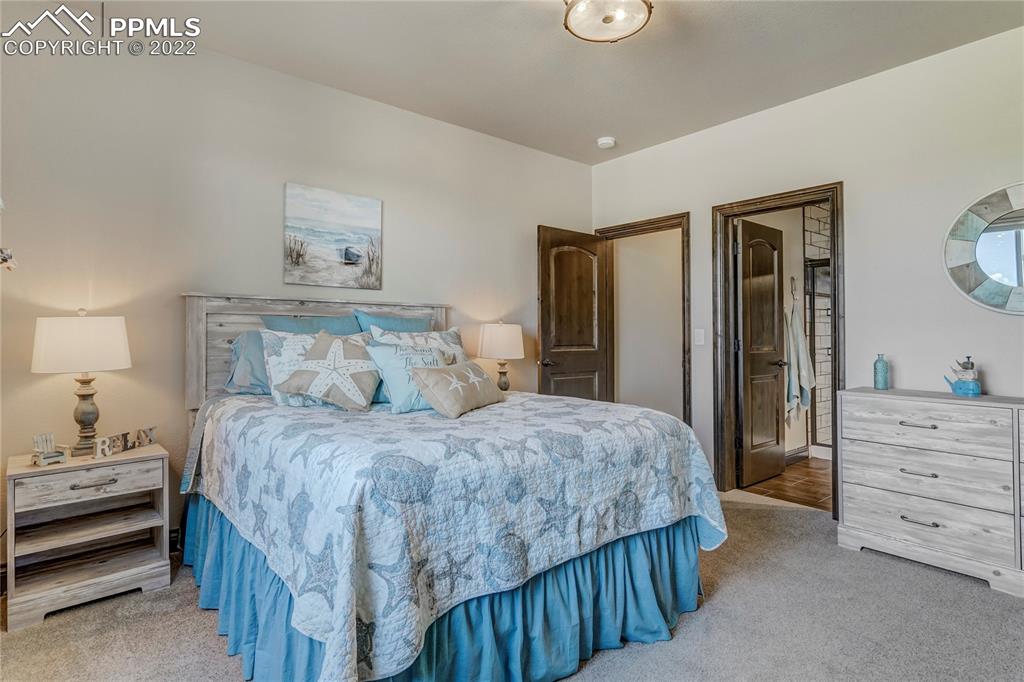 14325 Evans Road Elbert, CO 80106 - Photo 36 of 49 a bedroom with a bed and a dresser