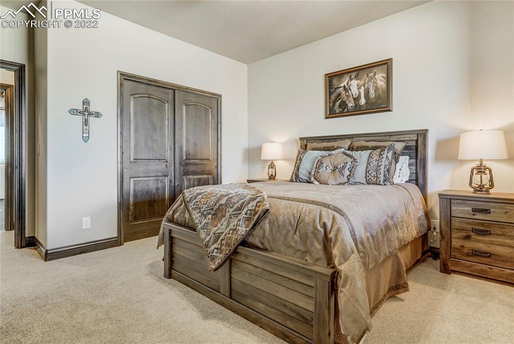 14325 Evans Road Elbert, CO 80106 - Photo 39 of 49 a bed room with a bed and a night stand