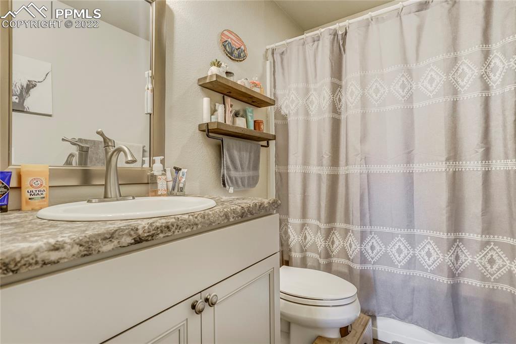 14325 Evans Road Elbert, CO 80106 - Photo 46 of 49 a bathroom with a granite countertop sink and a mirror