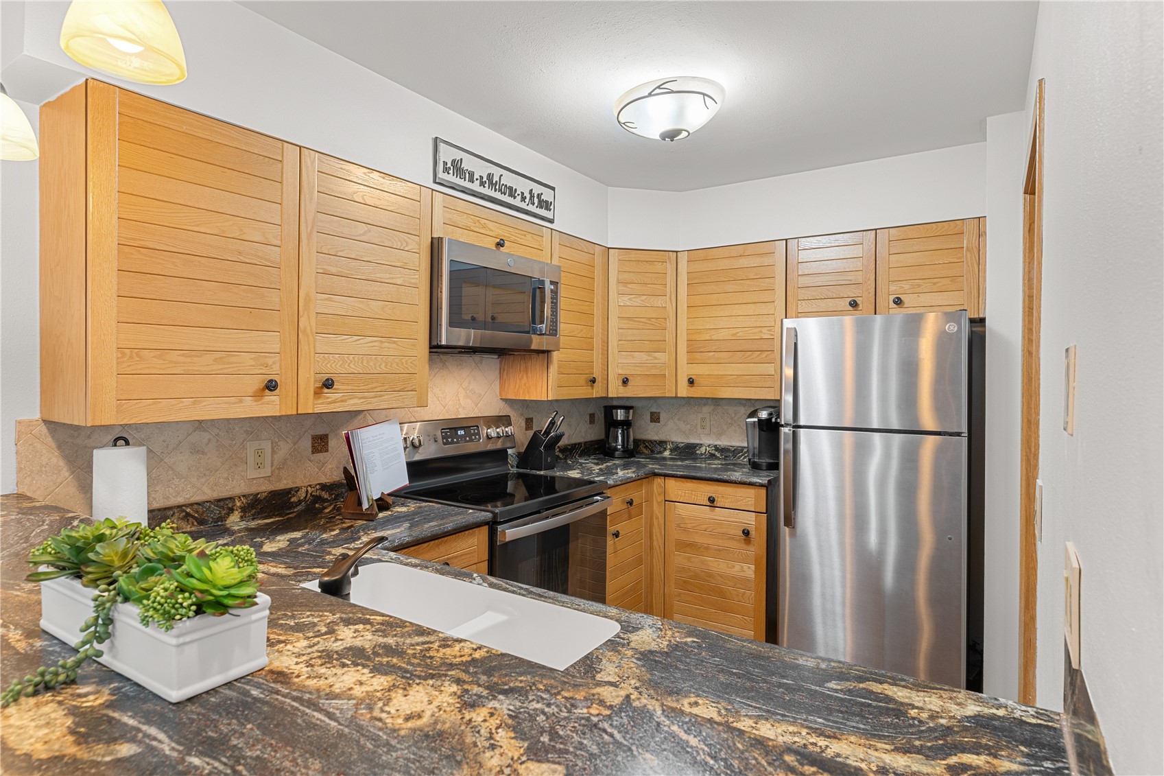 22804 Highway 6, Unit 102 Keystone, CO 80435 - Photo 8 of 34 a kitchen with a refrigerator and a sink