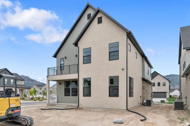 1567 North 3250 West Provo, UT 84601 - Photo 4 of 22 Modern two-story residence featuring light-colored stucco and board-and-batten siding