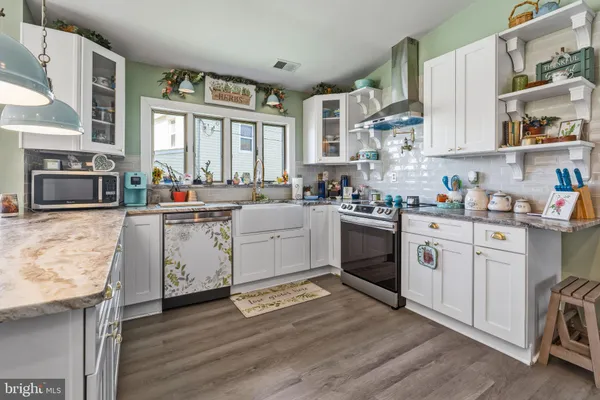 a kitchen with cabinets a sink and a stove