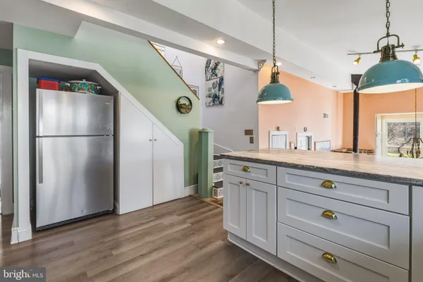a kitchen with a refrigerator a sink and a window