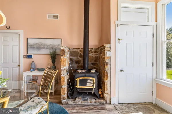 a view of a hallway with wooden floor and windows