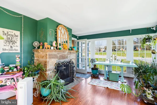 a living room filled with furniture a rug and a fireplace