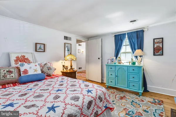 a bedroom with a bed and a dresser in it