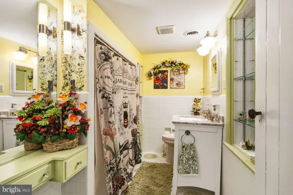 a bathroom with a sink mirror and vanity