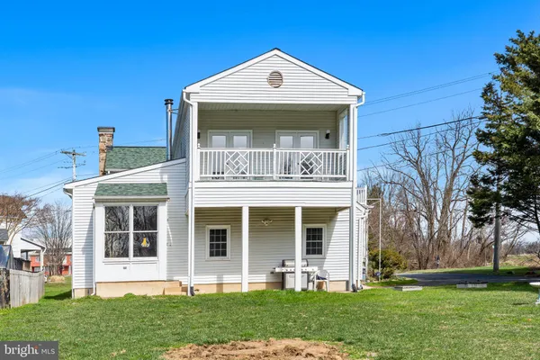 a front view of a house with garden and porch