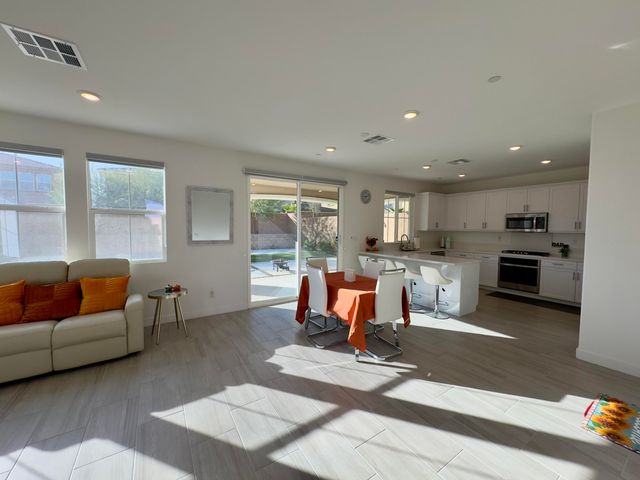 a living room with furniture and kitchen view