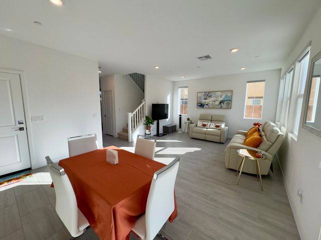 a living room with fireplace furniture and a wooden floor