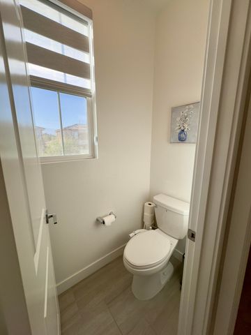 a white toilet sitting next to a window