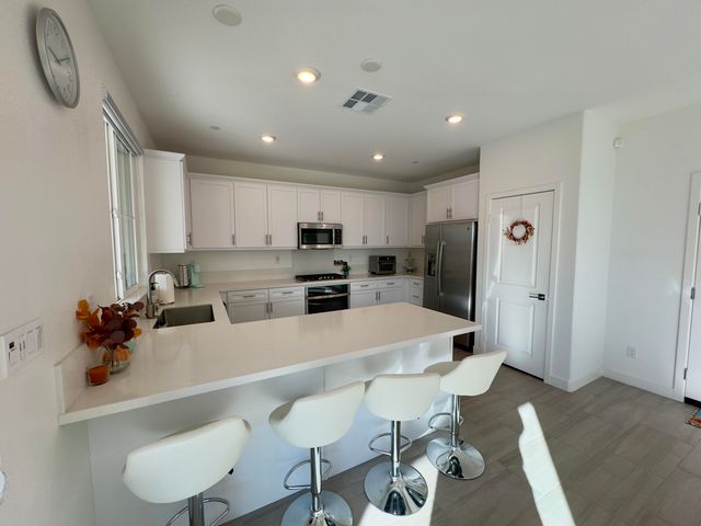 a large kitchen with a table and chairs in it