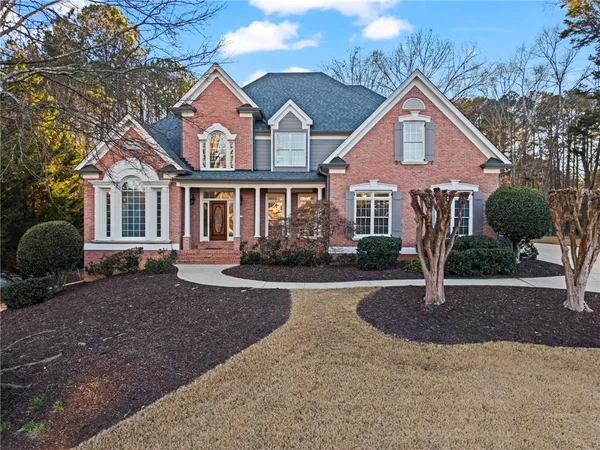 a front view of a house with a yard