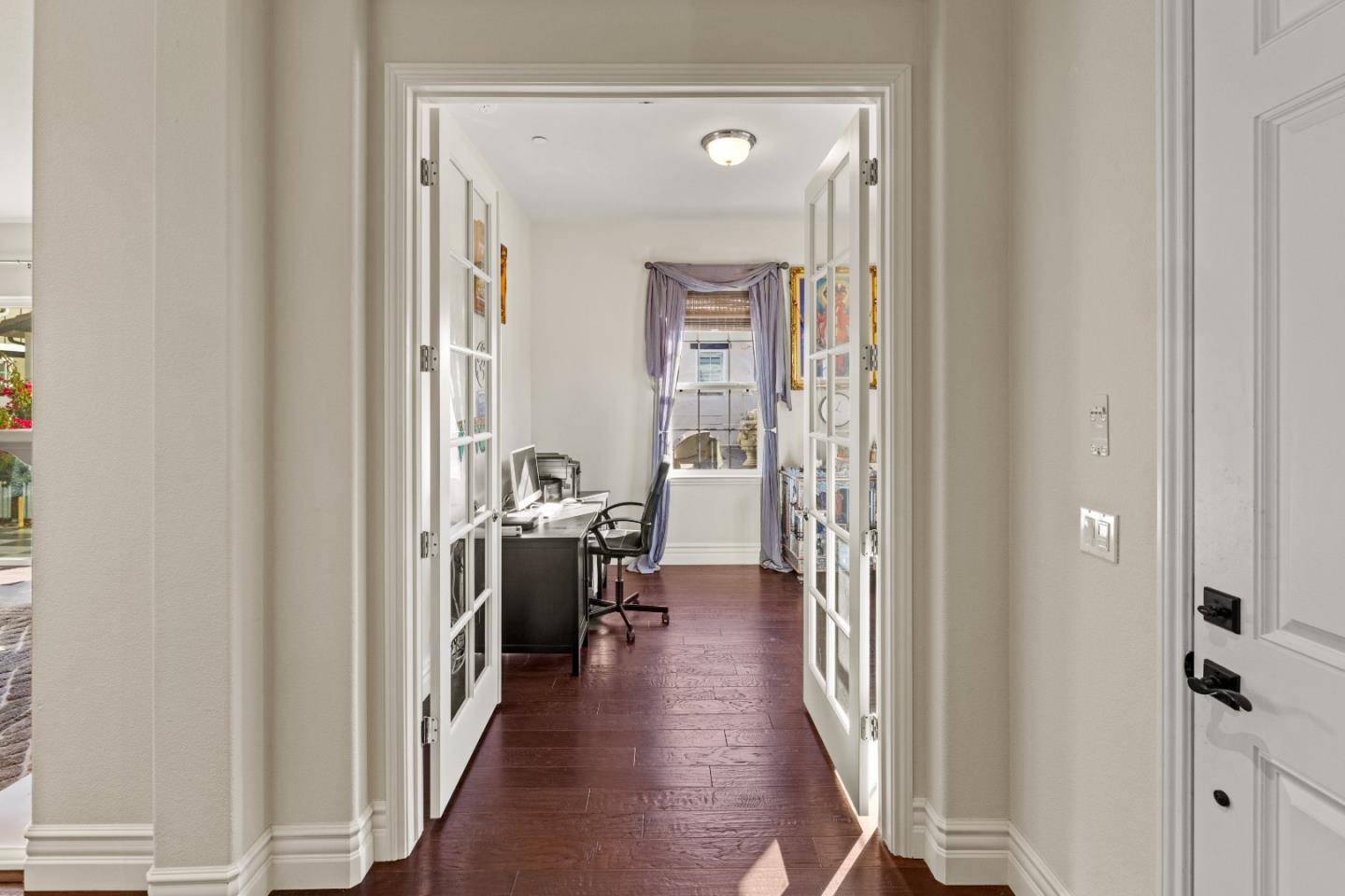 18511 McClellan Circle East Garrison, CA 93933 - Photo 44 of 65 a view of a hallway with wooden floor and a living room