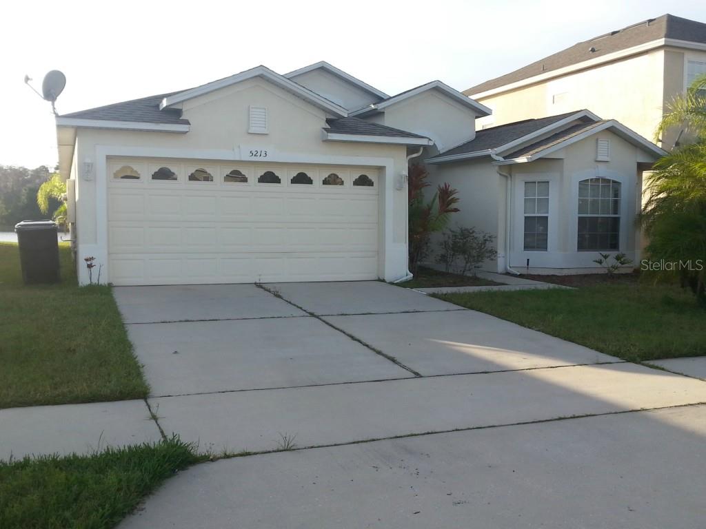 5213 Walnut Ridge Drive Orlando, FL 32829 - Photo 1 of 1 a front view of a house with a yard and garage